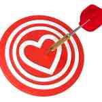Heart on dart board with dart.