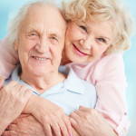 Happy elderly couple hugging in front of the camera